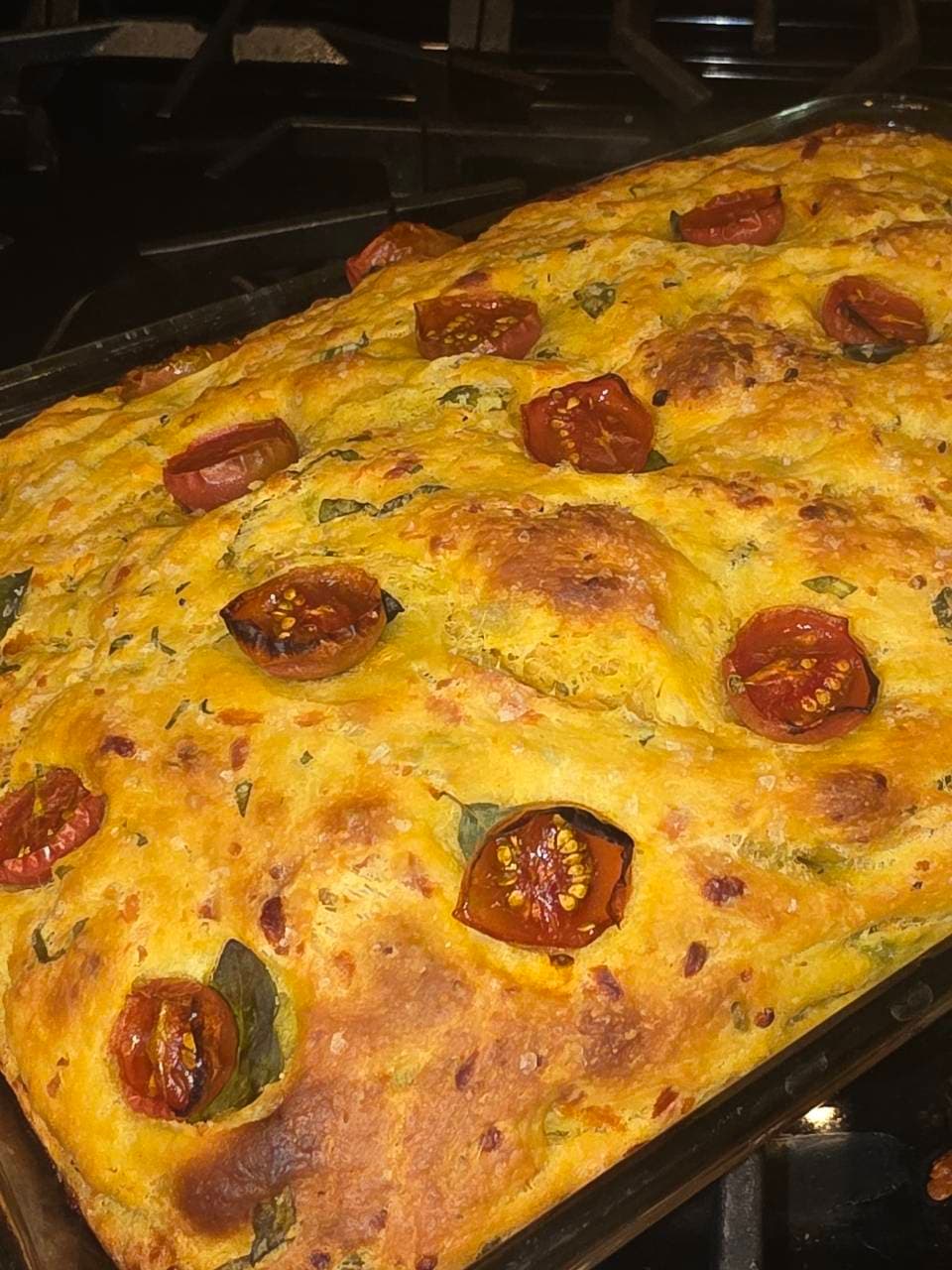 Focaccia made with tumeric. Home grown tomatoes garlic and basil from our garden (2/4)